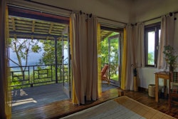 Guest bedroom with patio at Tiger Mountain Lodge, Nepal