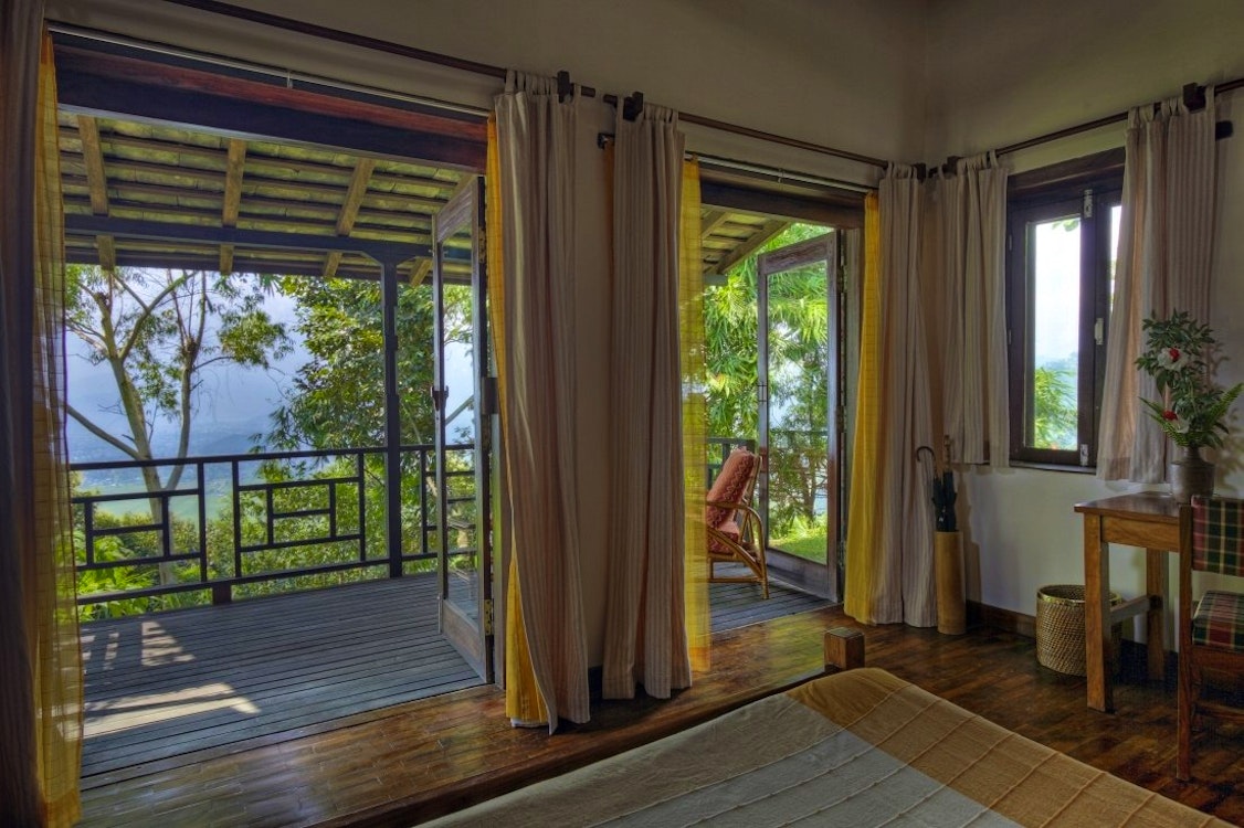 Guest bedroom with patio at Tiger Mountain Lodge, Nepal