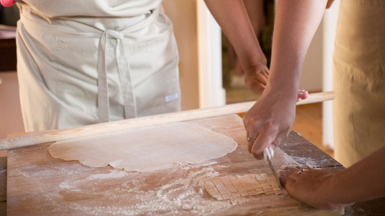 Rolling pastry in Greek cooking class